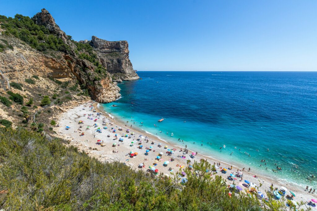 javea's breathtaking cove known for its deep blue waters, rocky surroundings, and peaceful ambiance.